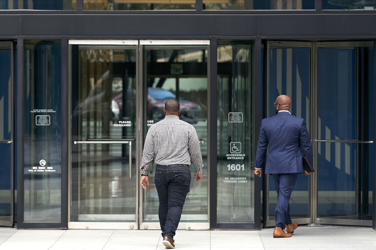 People enter an office building in downtown Dallas, Texas, on May 27.