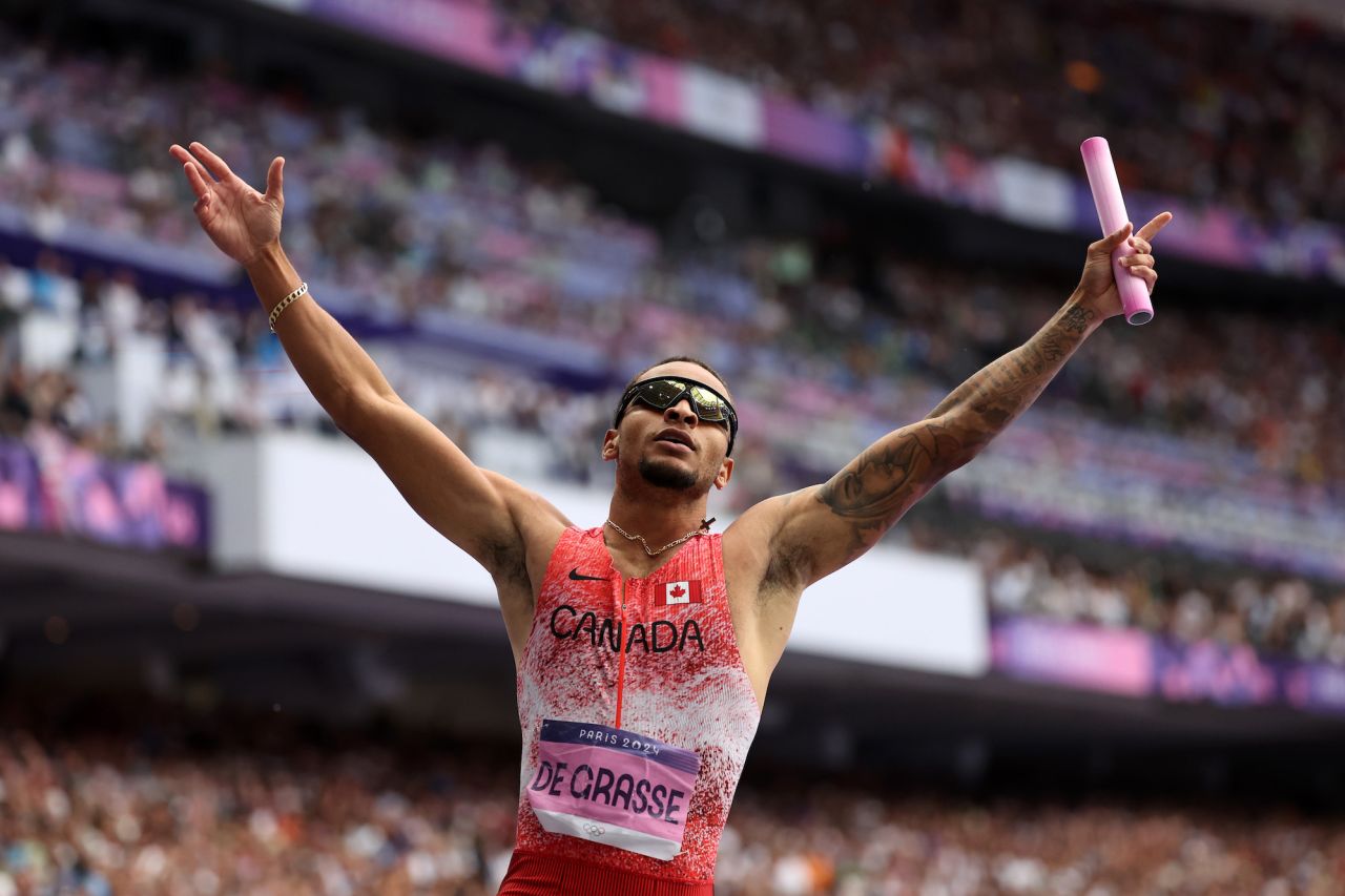 Andre De Grasse of Team Canada celebrates winning gold.