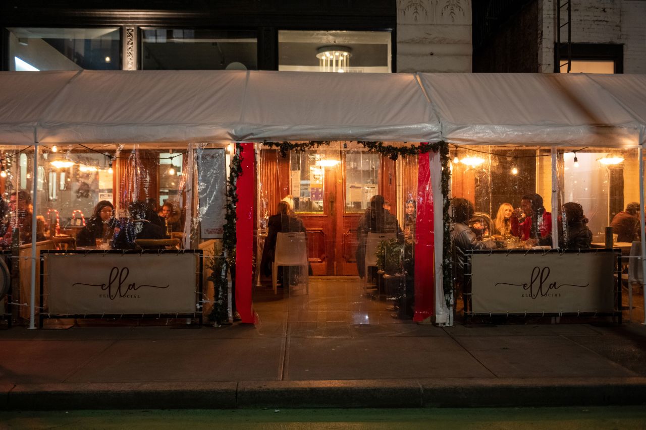 People dine outdoors under a plastic tent at a restaurant on the Upper West Side in New York on December 30, 2020.