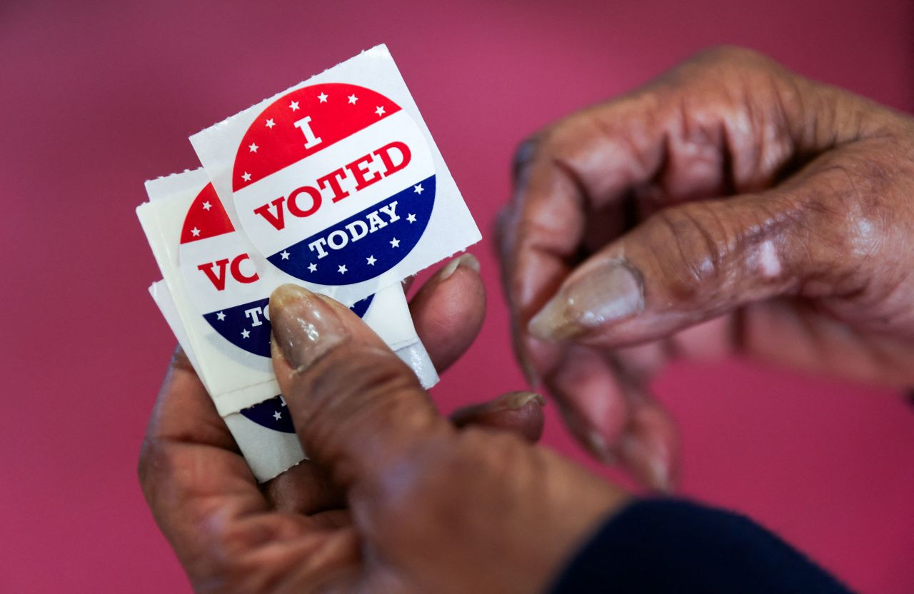 A poll worker holds stickers for voters in Columbia, South Carolina, on Saturday. 