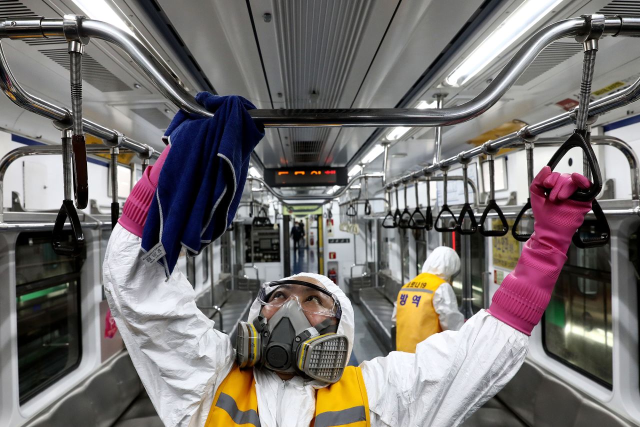 Disinfection workers wearing protective gear spray anti-septic solution against the coronavirus in a subway at Seoul metro railway base on March 11 in Seoul, South Korea.