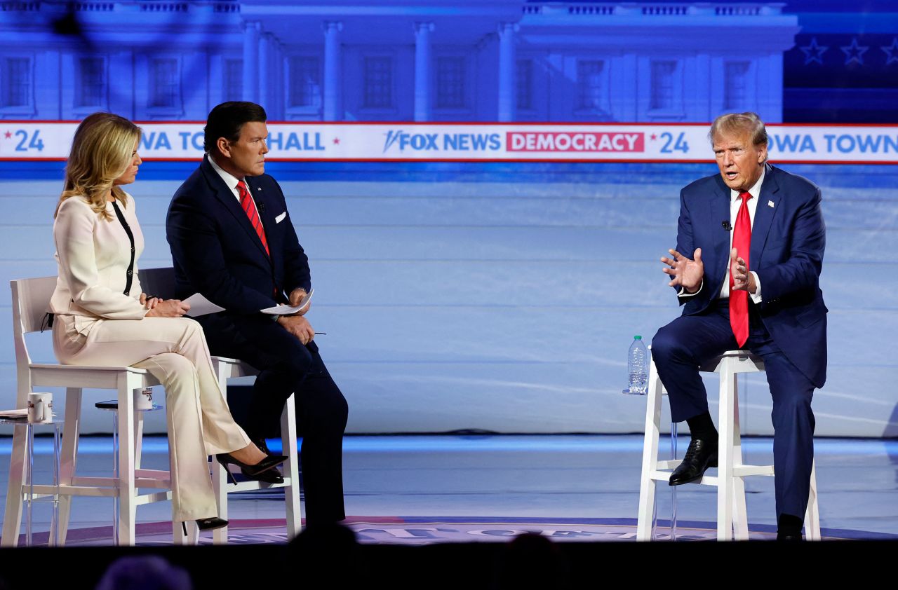 Former President Donald Trump speaks as moderators Bret Baier and Martha MacCallum look on during a town hall in Des Moines, Iowa, on Wednesday.