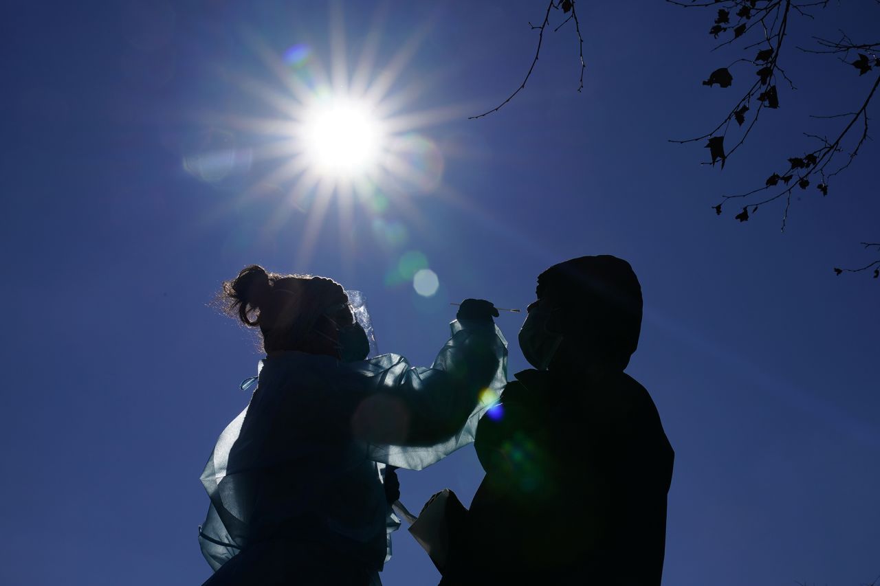 Registered nurse Laura Moore, left, swabs a patient during testing for Covid-19 organized by Philadelphia FIGHT Community Health Centers at Mifflin Square Park on Thursday, December 10, in south Philadelphia.