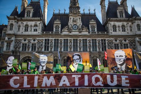 Environmental activists display portraits of world leaders in front of the Paris city hall on November 6, in France. 