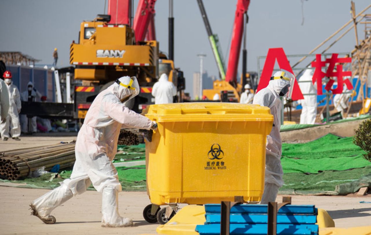 Workers transfer medical waste at Leishenshan Hospital, the newly-built makeshift hospital for novel coronavirus patients, in Wuhan in China's central Hubei province on February 18.