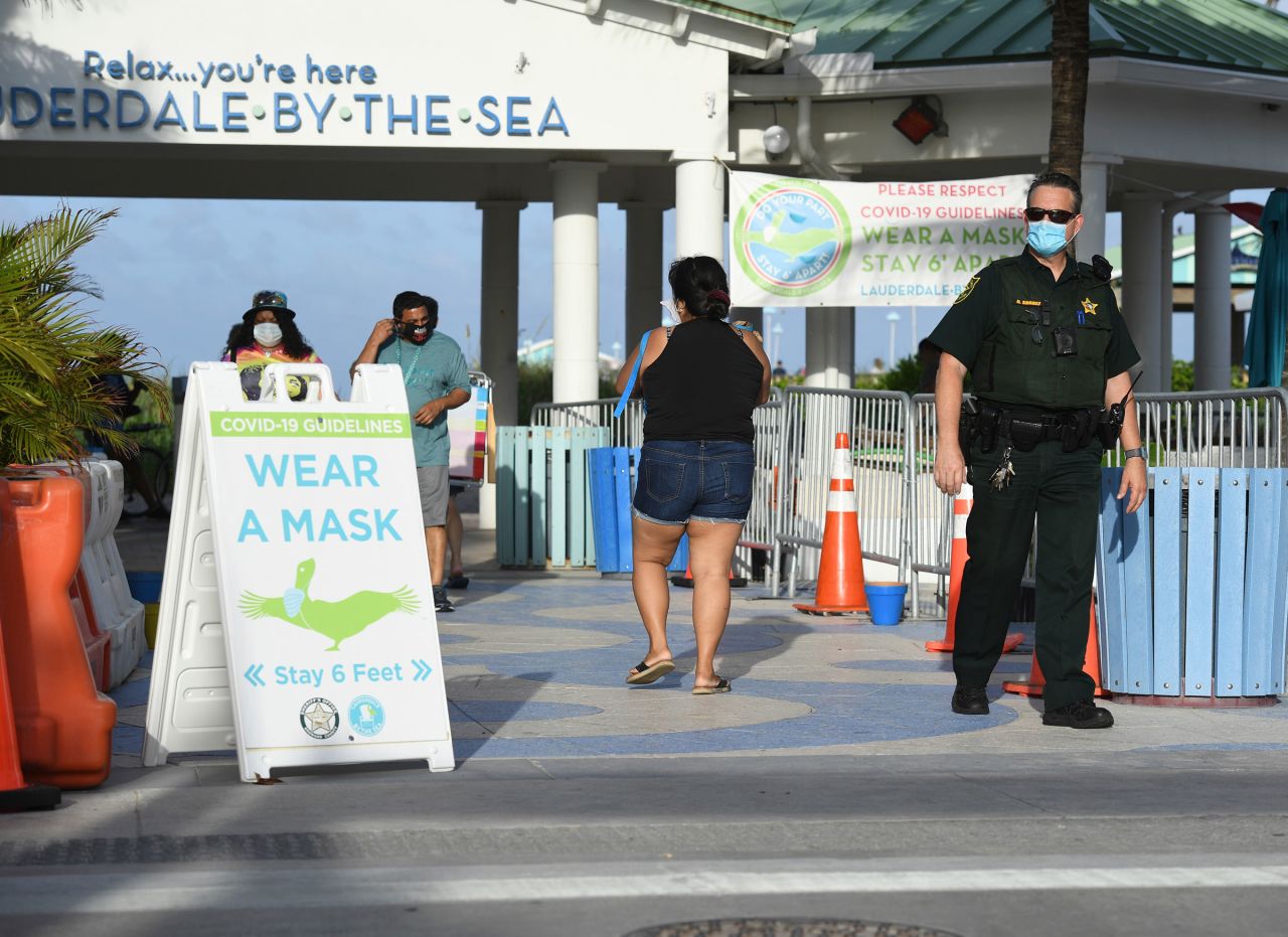 A sign asks people to wear a face mask in Fort Lauderdale, Florida, on Thursday.