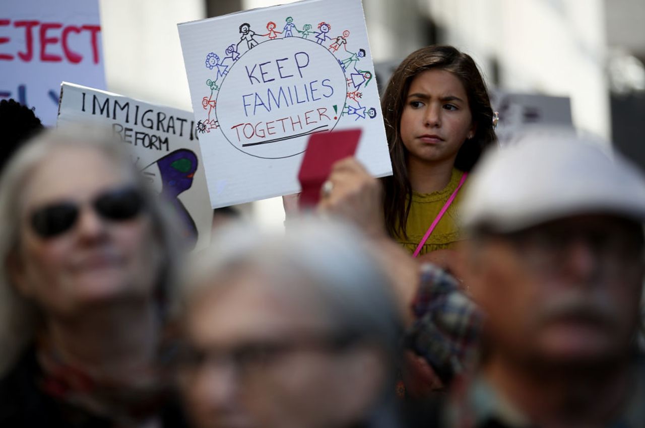 A young girl holds a sign during a demonstration outside of the San Francisco office of the Immigration and Customs Enforcement (ICE) on June 19, 2018 in San Francisco, California. 