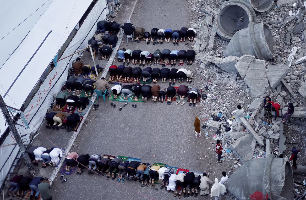 Palestinians hold Eid al-Fitr prayers by the ruins of al-Farouk mosque in Rafah, Gaza, on April 10.