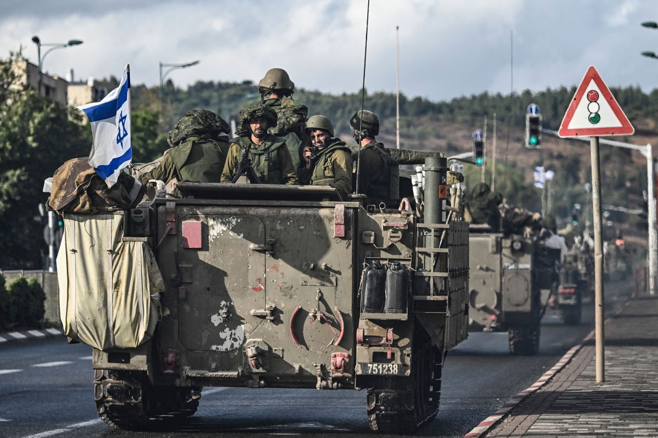 Israeli soldiers patrol in armoured personnel carriers at an undisclosed position in northern Israel near the border with Lebanon on October 15.