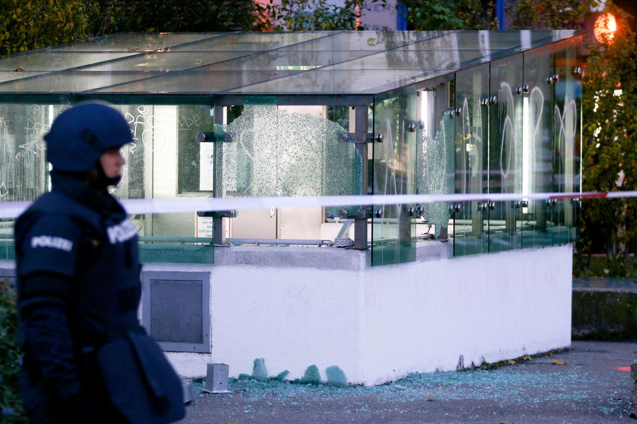 A police officer in Vienna stands near broken glass on November 3.