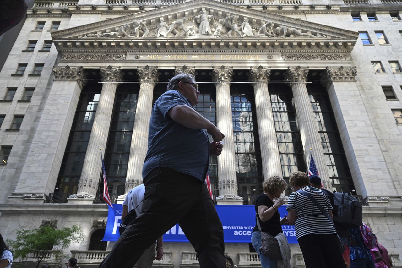 People walk past the New York Stock Exchange (NYSE) on June 4.