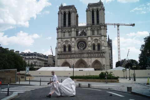 A worker cleans around the Notre Dame Cathedral in Paris on Monday, April 27. 