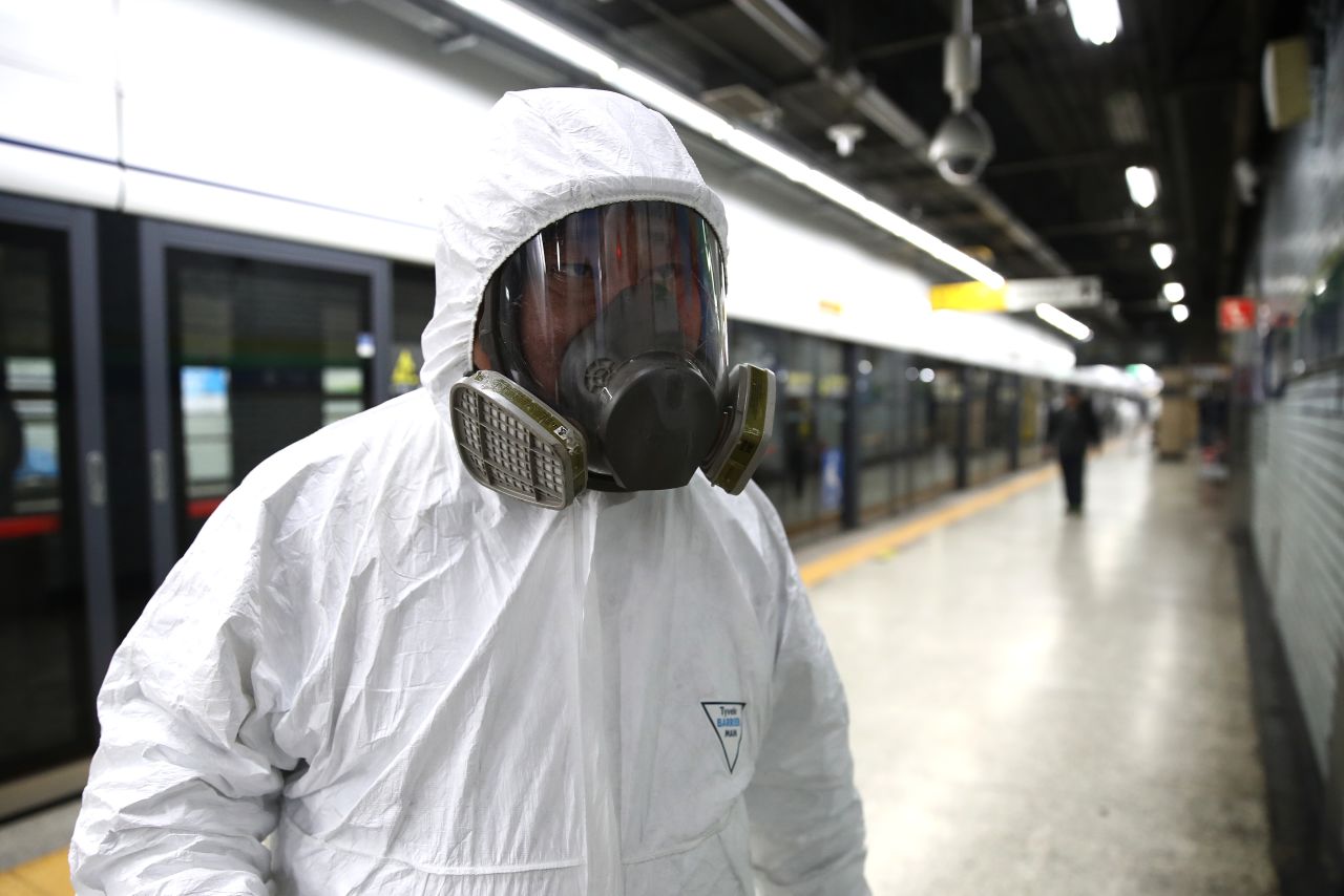 A disinfection worker wears protective gear and prepares to disinfect against the coronavirus at a subway station in Seoul.