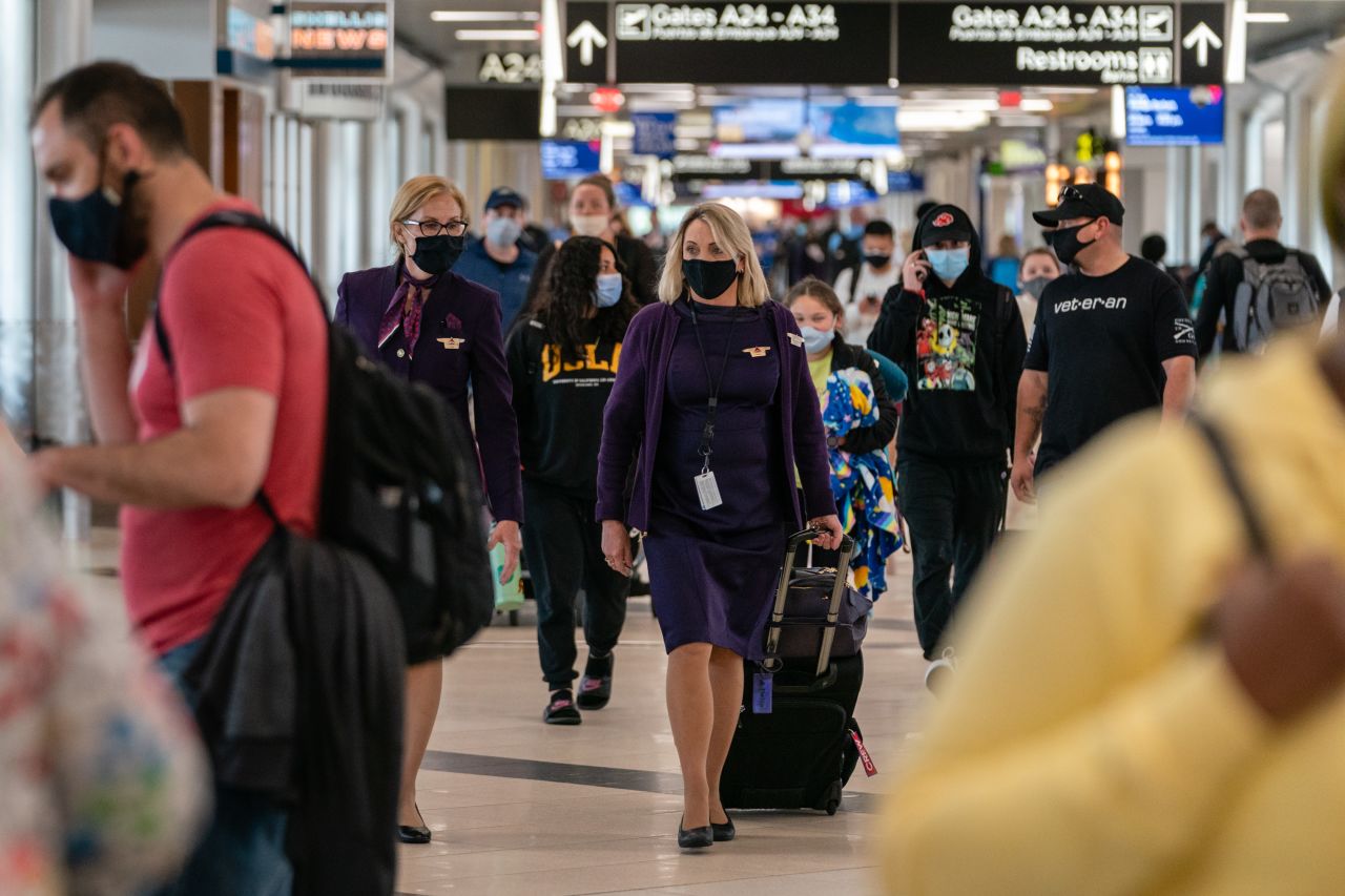 Flight attendants wearing protective masks walk through Hartsfield-Jackson Atlanta International Airport in Atlanta, Georgia, U.S., on Wednesday, April 7, 2021. 