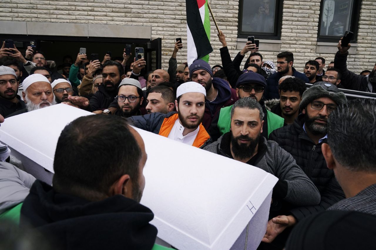 Family members of Wadea Al Fayoume, a six year-old who was stabbed to death, bring out his casket from Mosque Foundation to the hearse in Bridgeview, Illinois, on October 16.