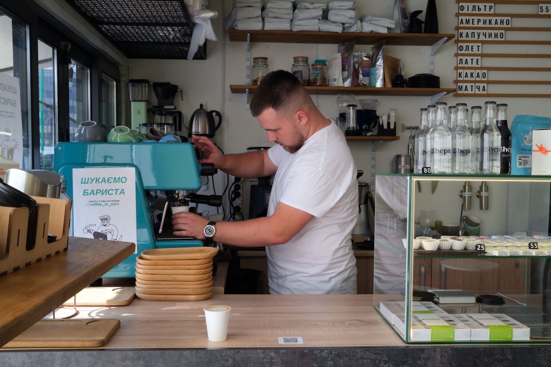 Maksym Holubchenko makes coffee at a Kyiv cafe that was running on a generator on Monday.