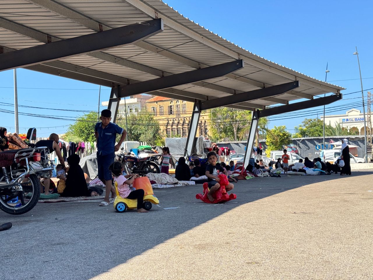 This parking lot in Sidon has turned into a makeshift camp for Syrian IDPs buzzing with children.