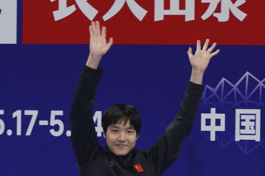 Yu celebrates on the podium after competing in the women's 400m individual medley event at the National Championships in China.