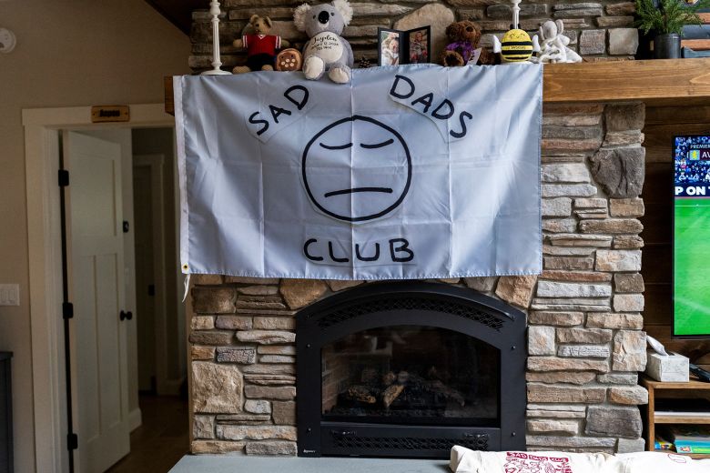 Attendees of the Sad Dads Club retreat place items of remembrance of their children who have died on the mantle of a fireplace at the retreat in Raymond, Maine.