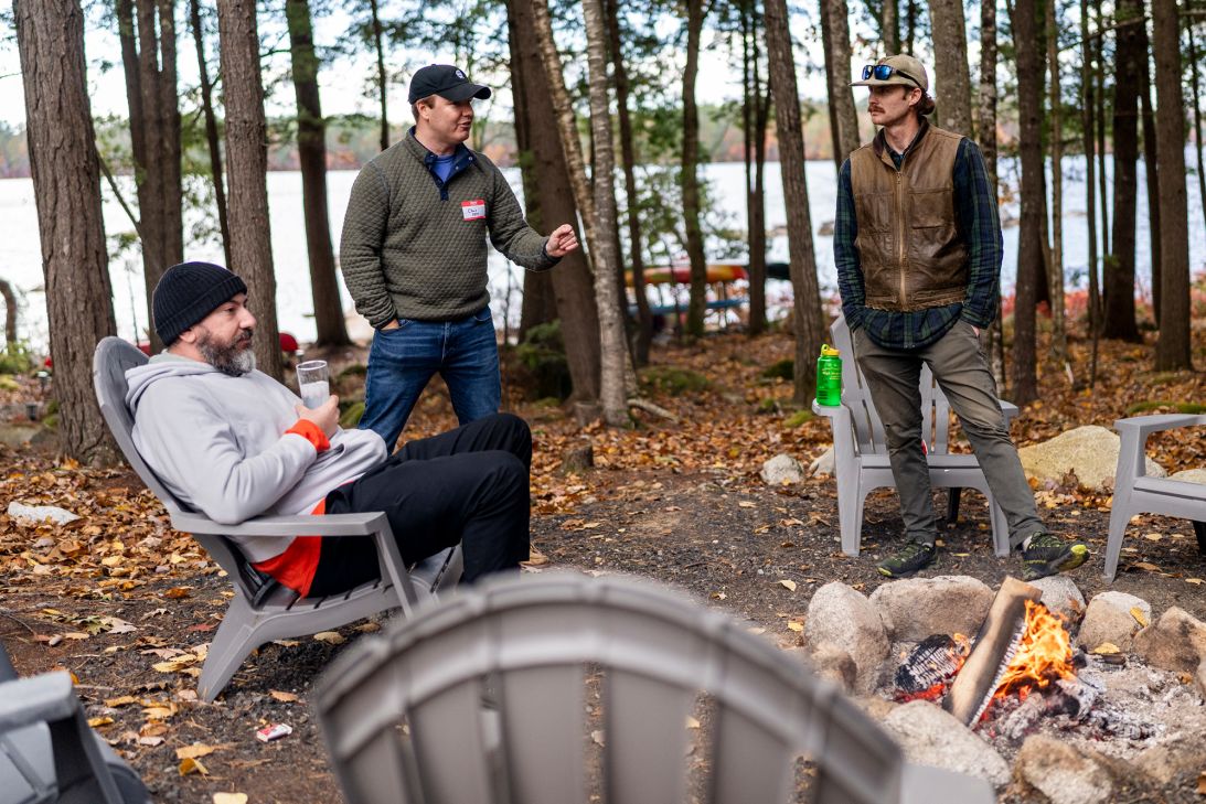 From left, Philip Leff, Christopher Piasecki and Michael MacDonald spend time around the campfire.