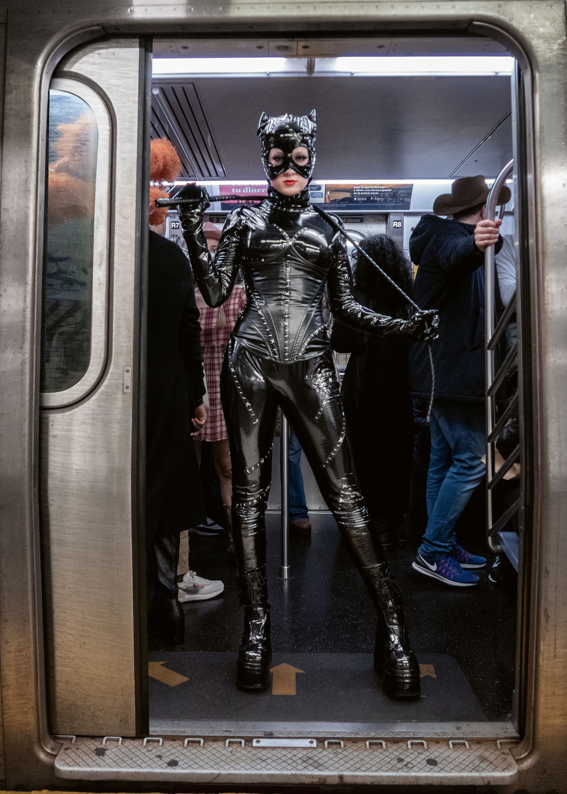 Catwoman stands clear of the closing doors.