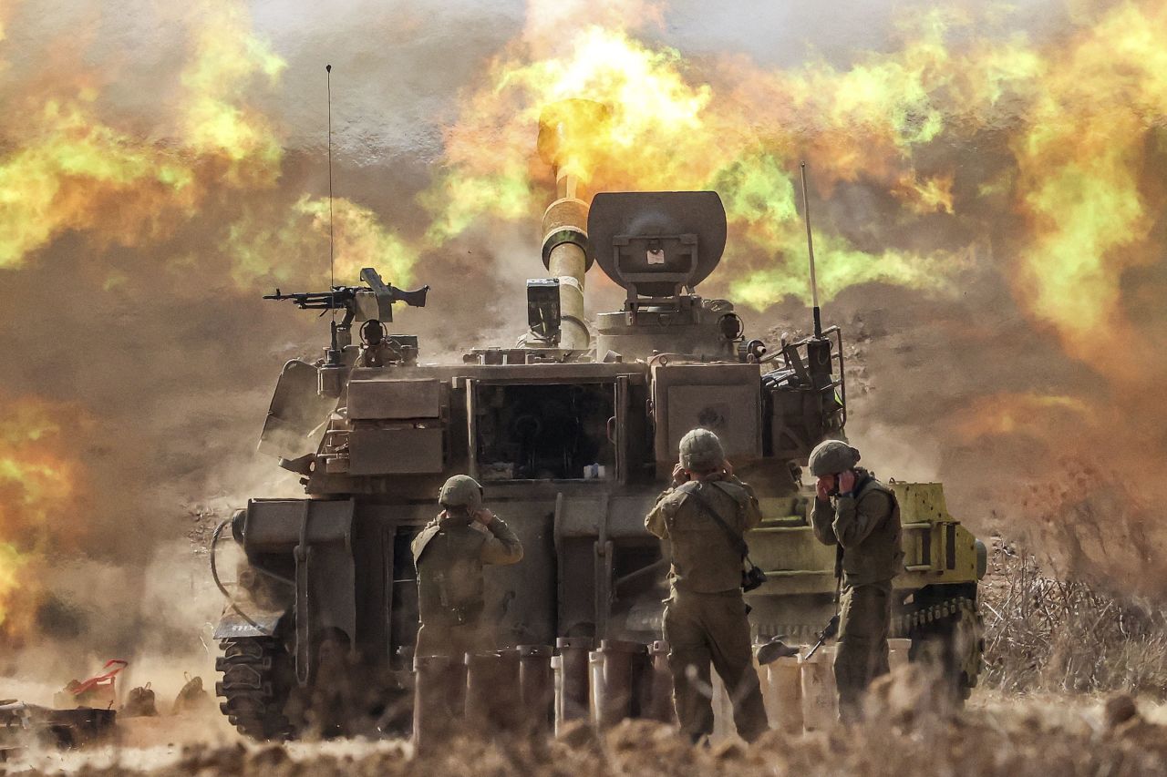 An Israeli army self-propelled howitzer fires rounds near the border with Gaza, in southern Israel, on October 11, 2023.