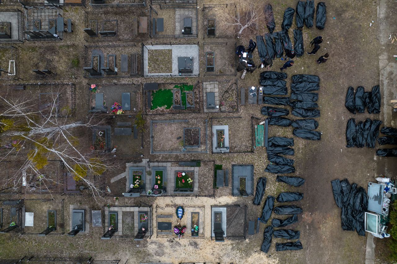 Police work on the identification process following the killing of civilians in Bucha, before sending the bodies to the morgue, on the outskirts of Kyiv, Ukraine, on Wednesday, April 6.