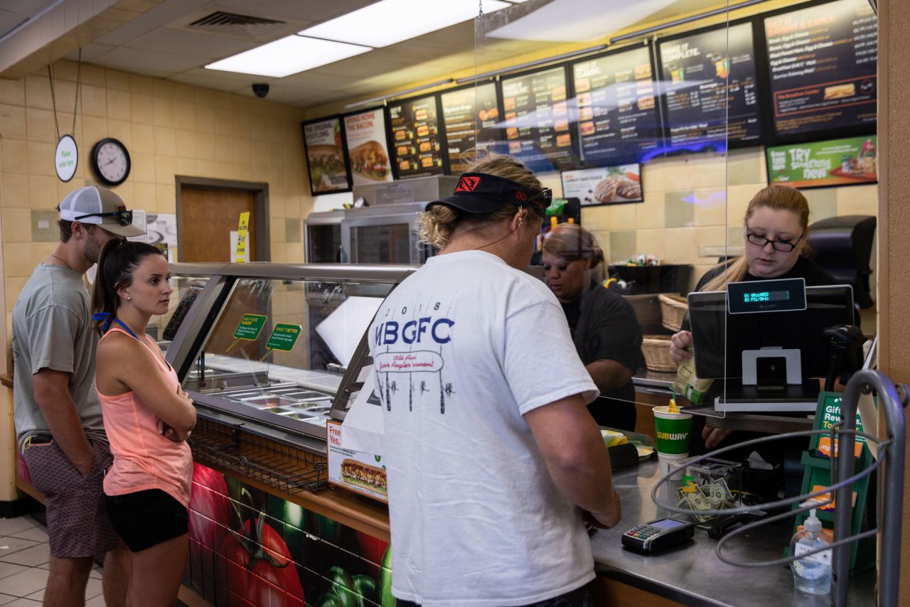 Customers wait in line to place orders at a fast food restaurant in Dauphin Island, Alabama, on May 1.