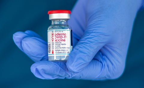 A registered nurse holds a vile of the Moderna COVID-19 vaccine before administering it to healthcare employees in Anaheim, California, on January 8.