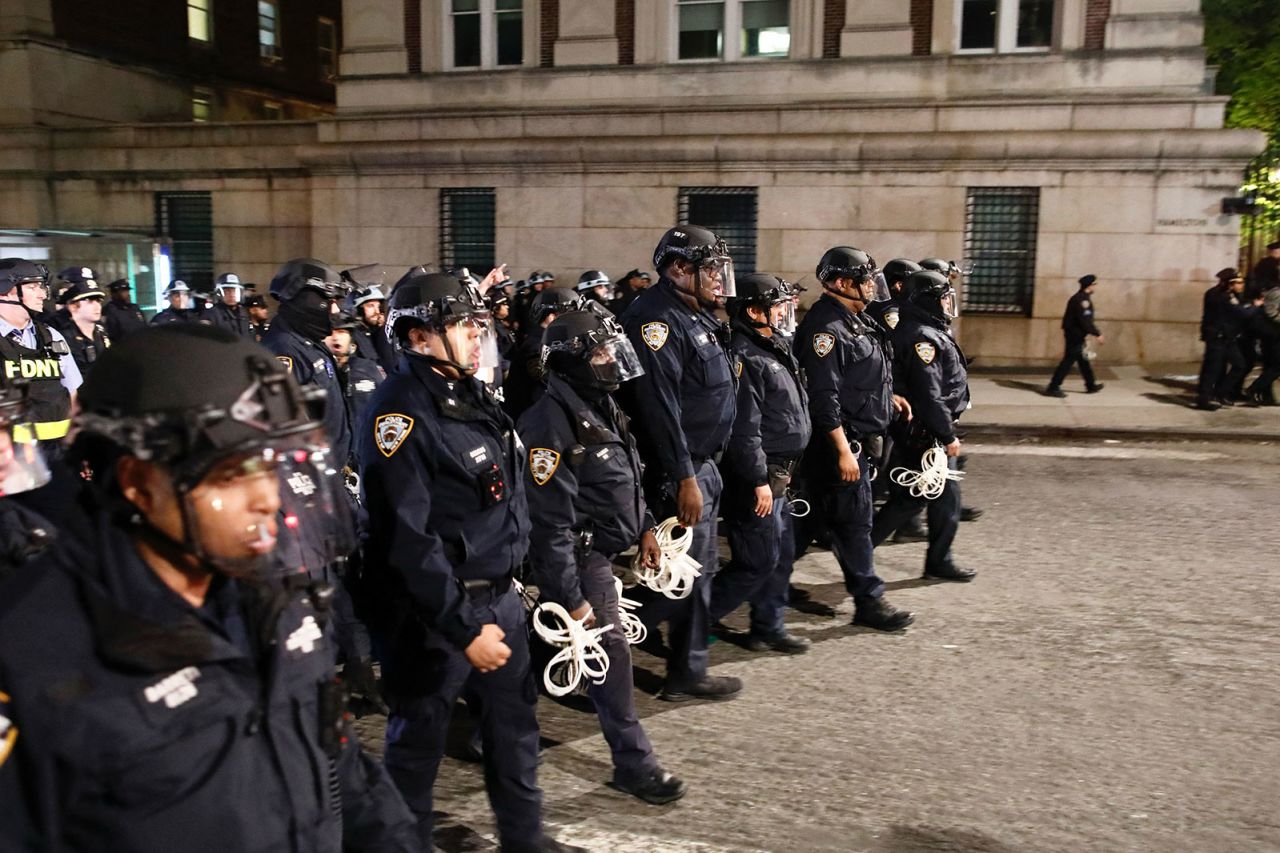 NYPD officers march onto Columbia University campus in New York on April 30.