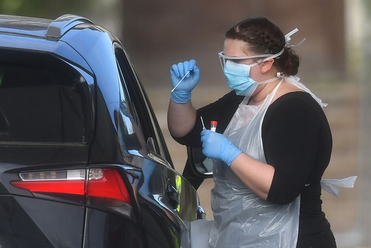 NHS workers are swabbed at a drive-in facility to test for the novel coronavirus,in Chessington, England on Thursday, April 2.