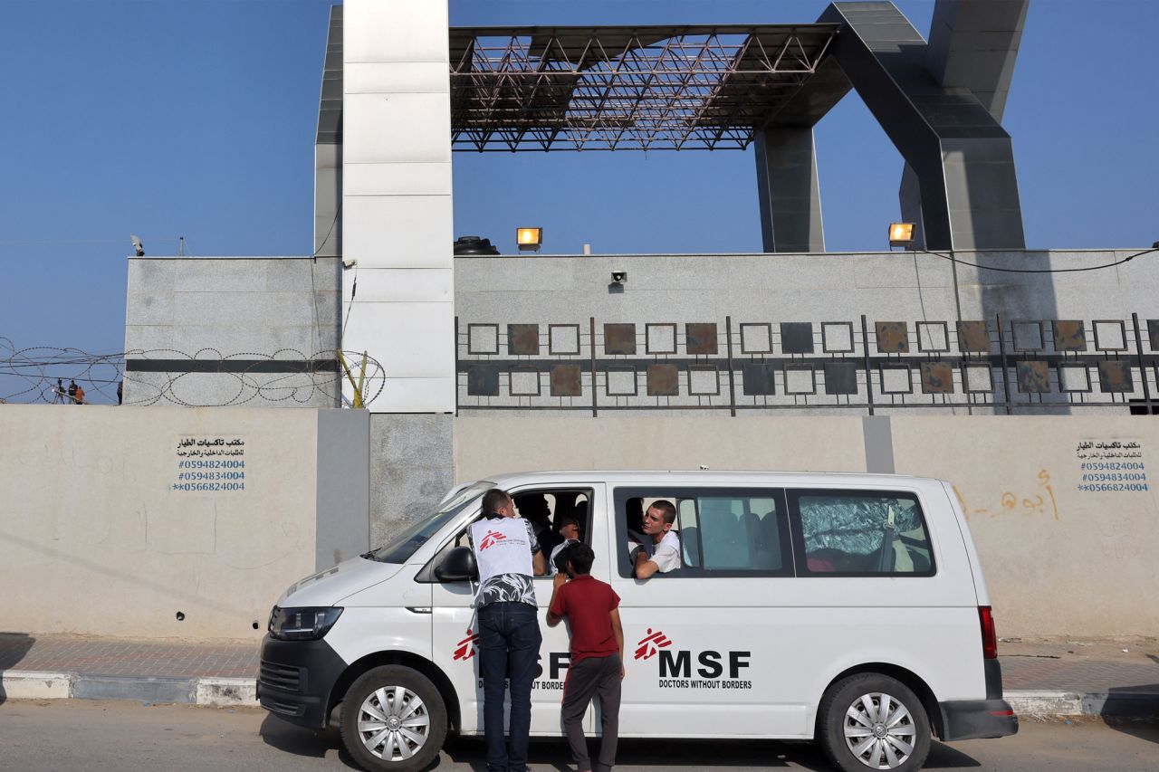 People wait inside a vehicle belonging to Doctors Without Borders (MSF) outside the gate of the Rafah border crossing with Egypt in southern Gaza on November 1, 2023.