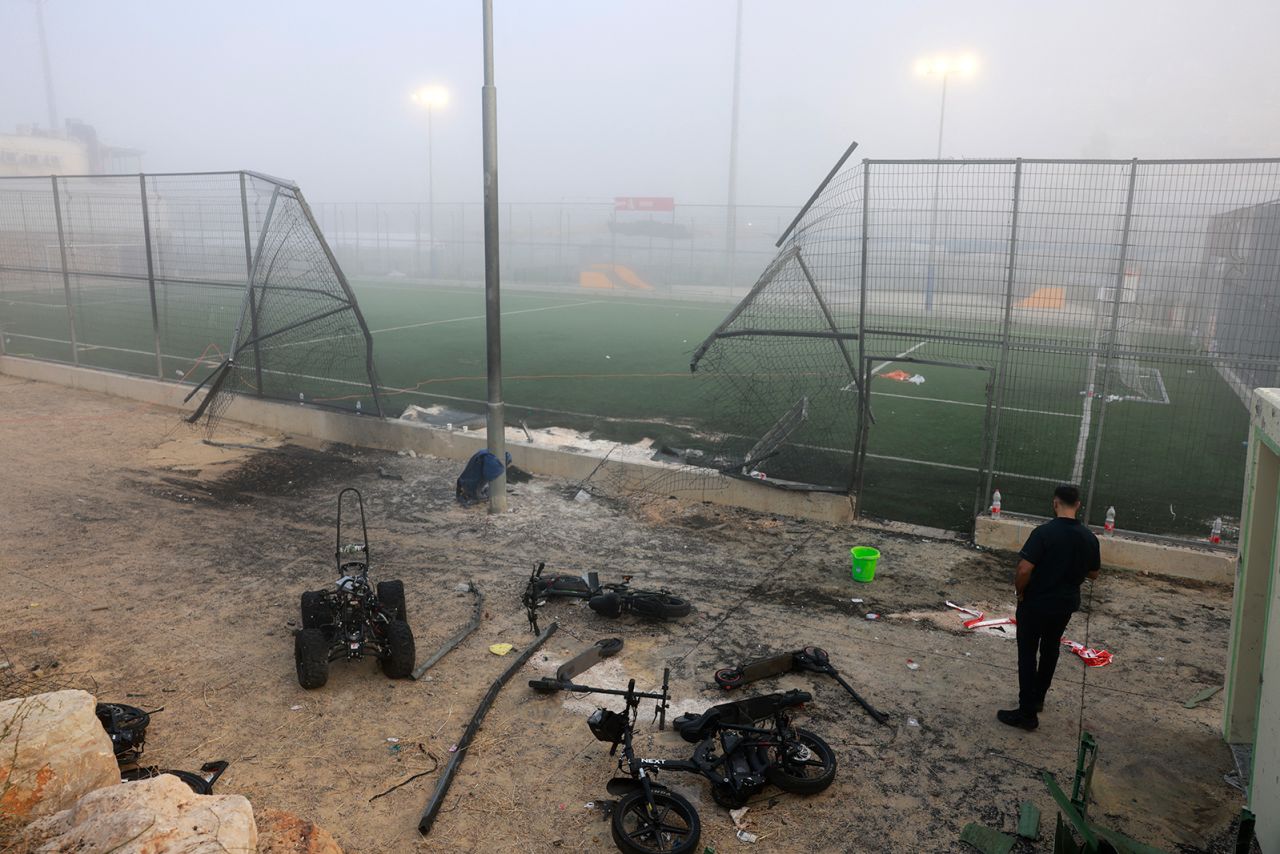 A man stands near a damaged gate around a football pitch after a reported strike in Majdal Shams village in the Israeli-annexed Golan area on July 28.