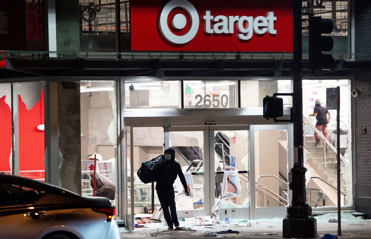 A looter leaves a Target store in Oakland, California, on May 30.