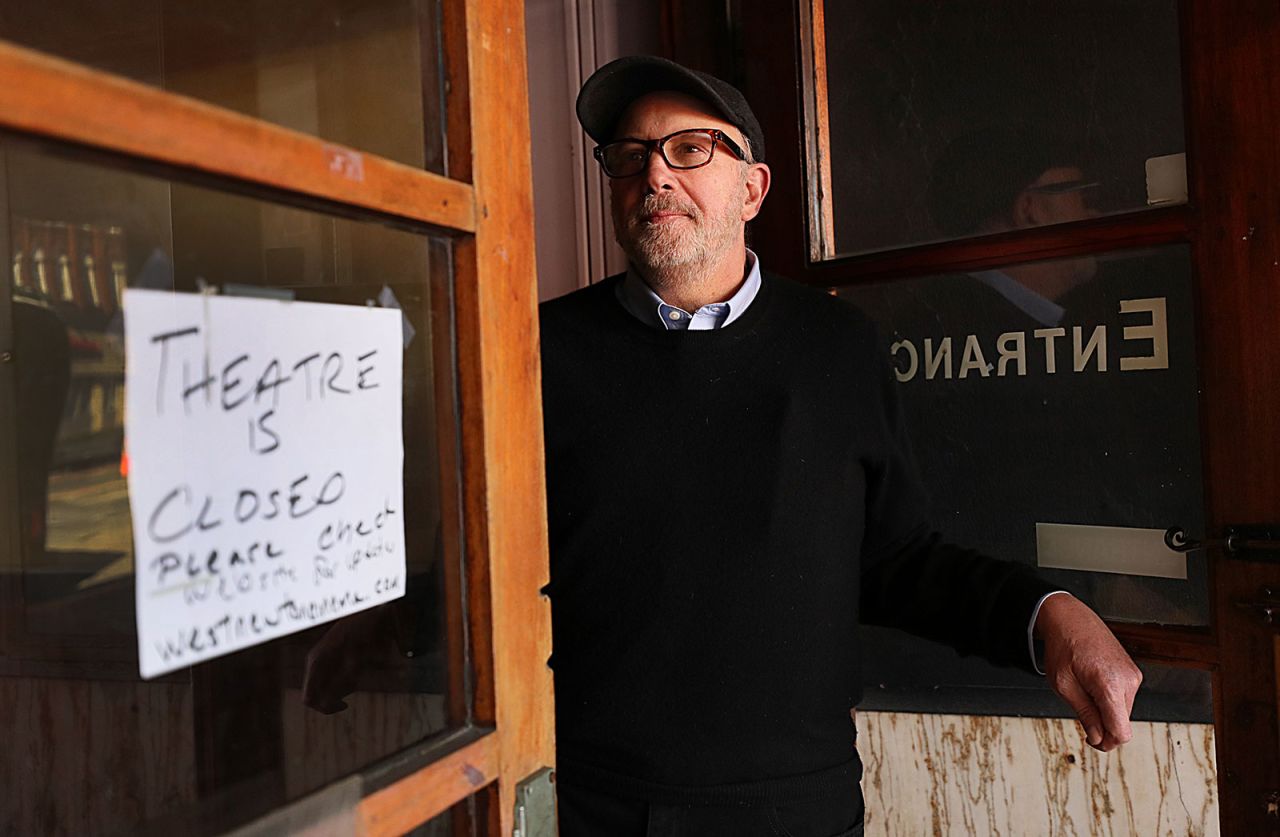 David Bramante, the owner of West Newton Theatre in Newton, Massachusetts, stands in the doorway of the theater on March 27. Bramante had to close the theatre due to the coronavirus pandemic.