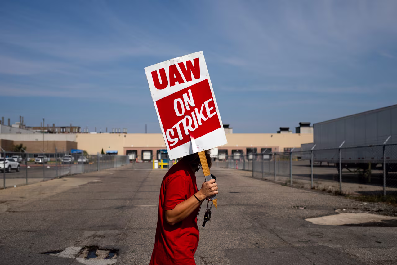 A "UAW On Strike" sign held on a picket line outside the main entrance at the General Motors Co. Ypsilanti Processing Center in Ypsilanti, Michigan, today.
