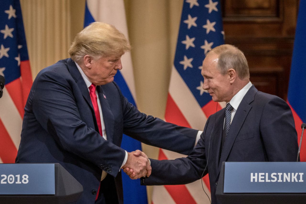 President Donald Trump (L) and Russian President Vladimir Putin shake hands during a joint press conference after their summit on July 16, 2018 in Helsinki, Finland.