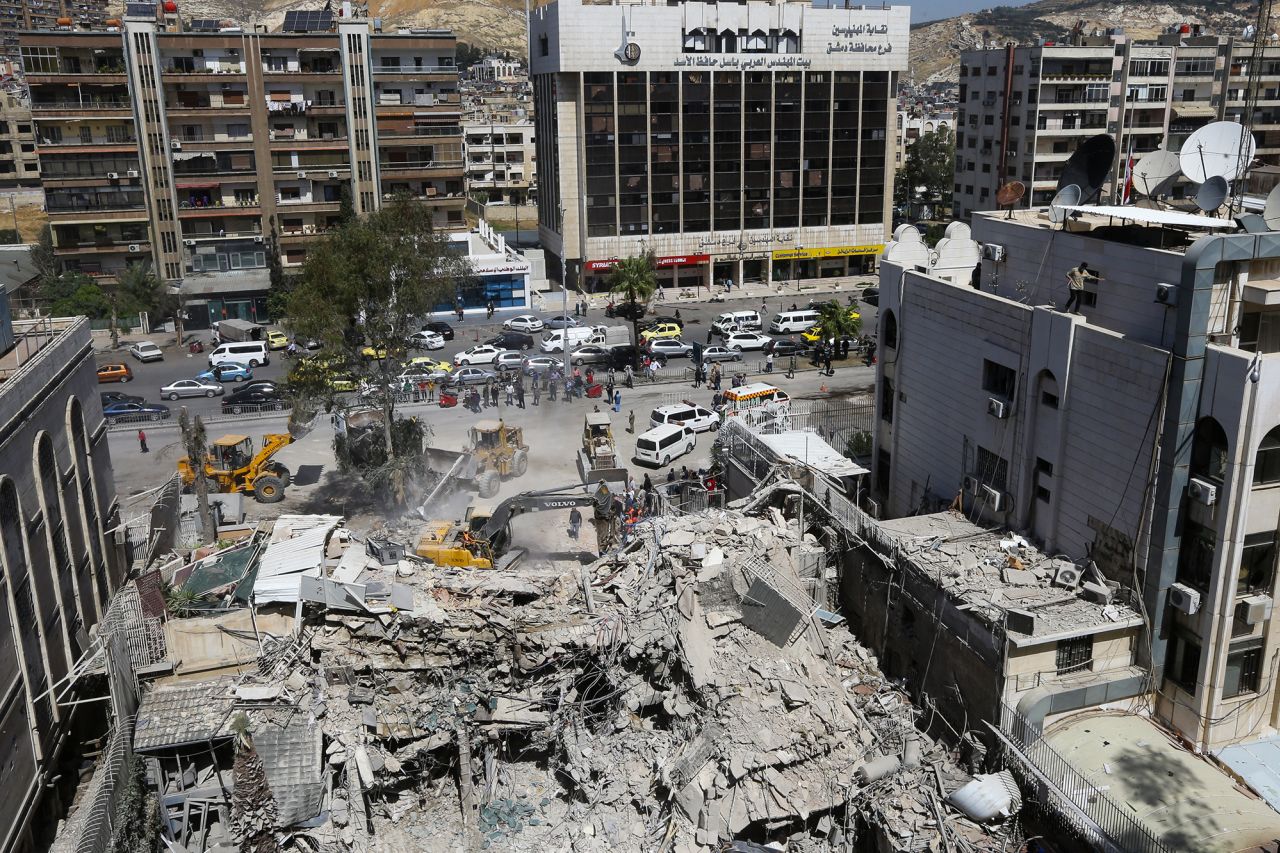 Rescue workers search in the rubble of a building annexed to the Iranian embassy a day after an Israeli air strike in Damascus, Syria, on April 2.