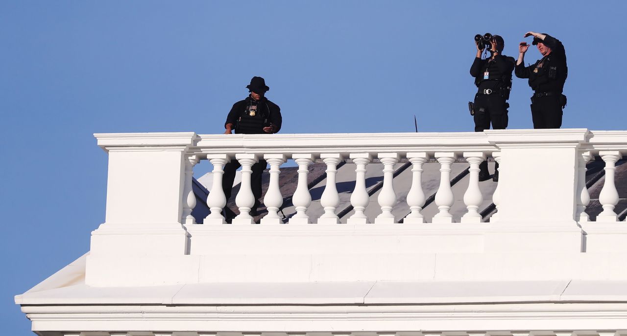 U.S. Secret Service Agents positioned atop of the White House as U.S. President Donald Trump returns from St. John's Episcopal Church in Washington, D.C., on Monday, June 1. 