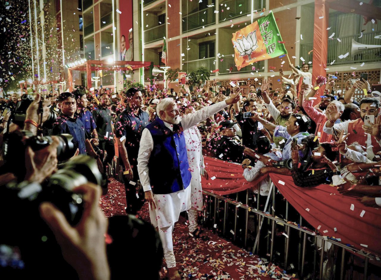 Prime Minister Narendra Modi is greeted by supporters as he arrives at the BJP headquarters in New Delhi on Tuesday.
