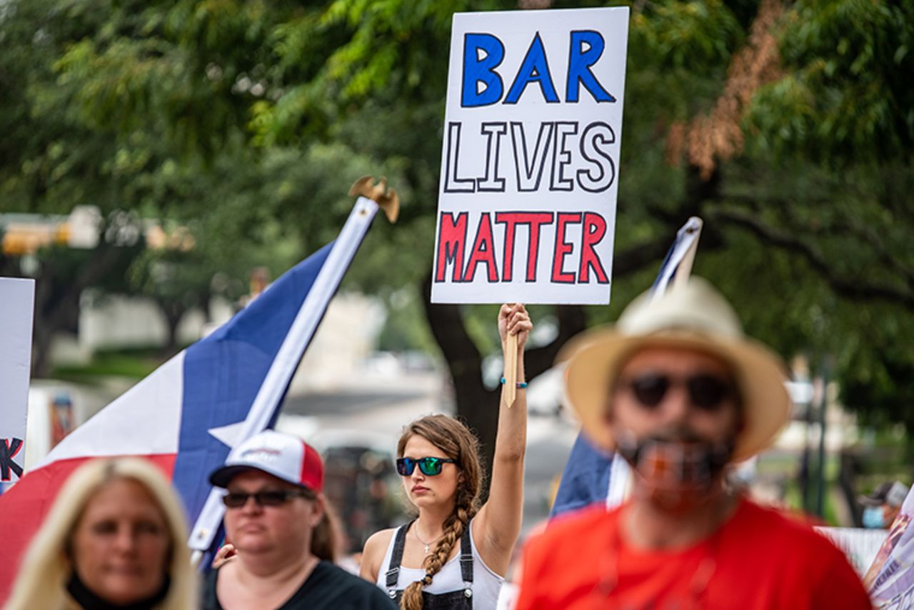 A demonstrator holds up a sign during a "Bar Lives Matter" protest in Austin, Texas, on June 30. Gov. Greg Abbott's ordered to close bars on June 26. 