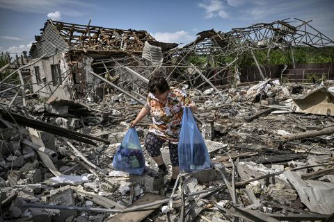 A woman collects belongings from rubble in Sloviansk on June 1.