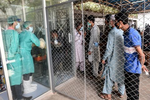 People wait in line to take a Covid-19 test in Karachi, Pakistan, on July 23.  