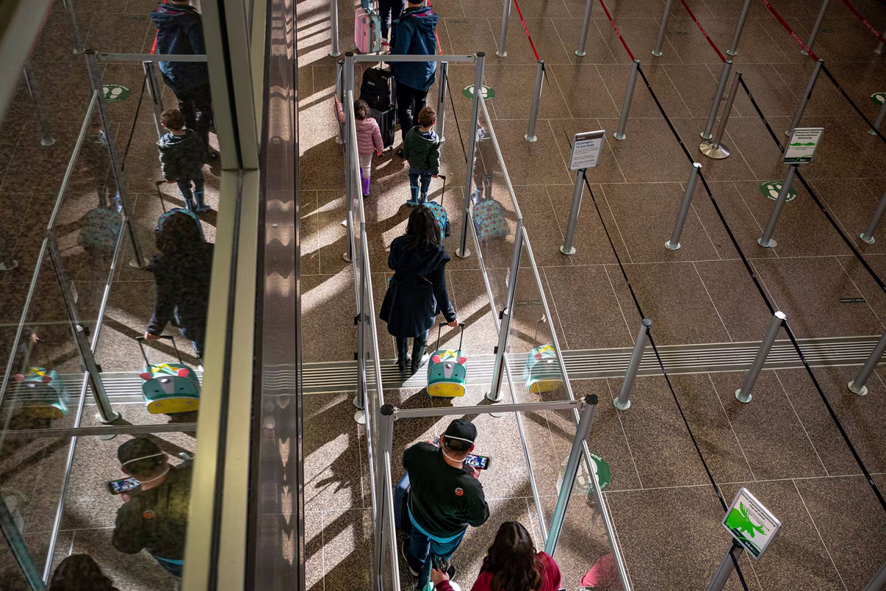 Travelers wait in line for security screening at Seattle-Tacoma International Airport in Seattle, on November 29.