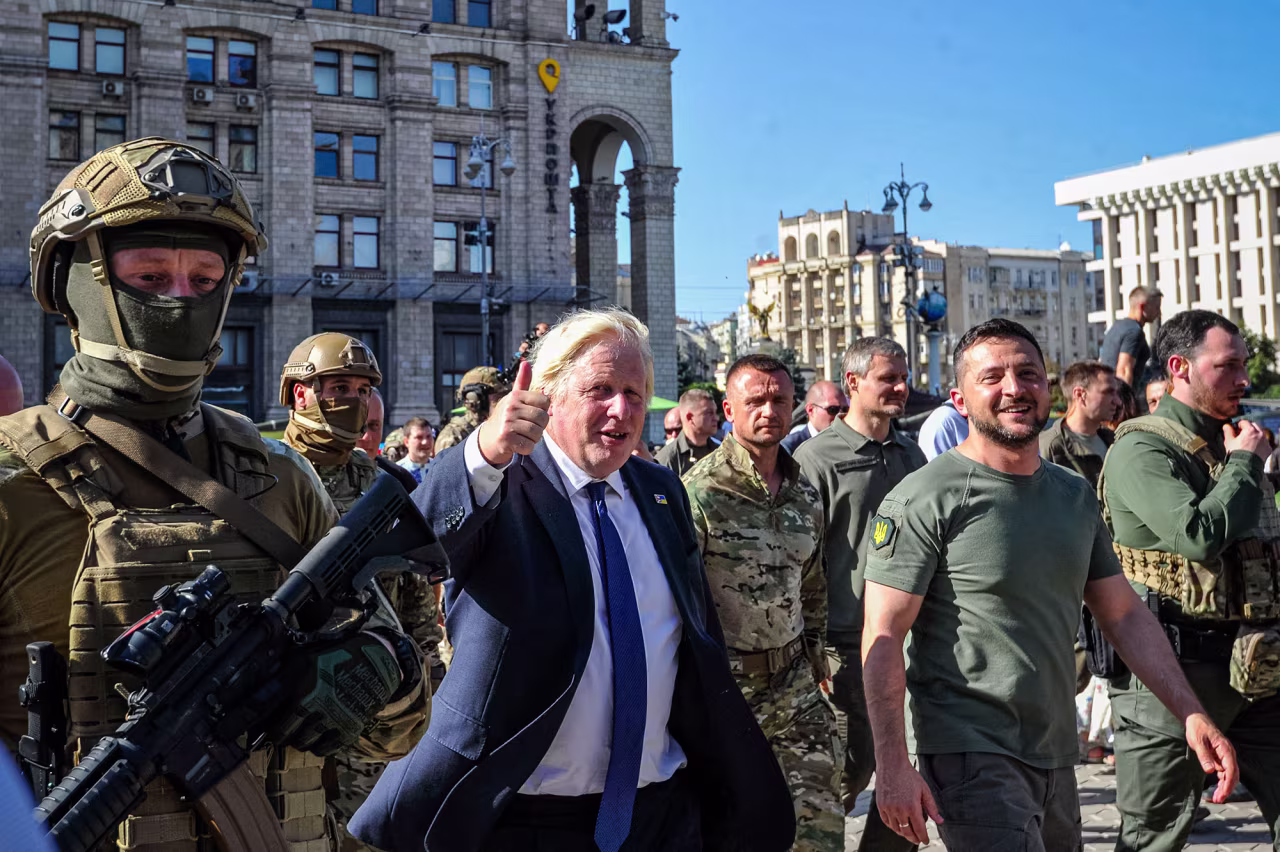 British Prime Minister Boris Johnson, center, and Ukrainian President Volodymyr Zelensky, right, walk at Kyiv's "Maidan" Independence Square on Ukraine's Independence Day on August 24.