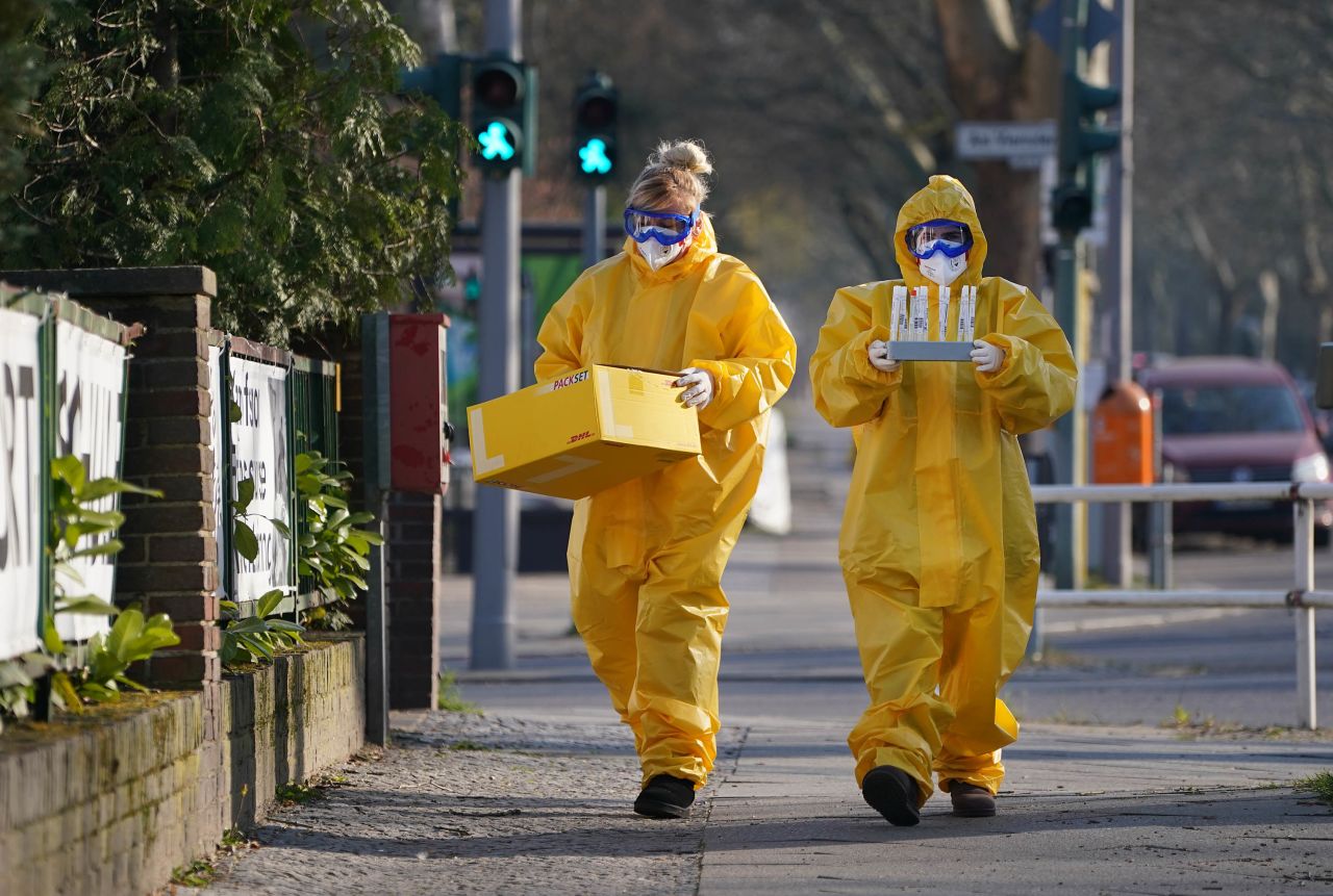 Workers return to a medical practice after taking Covid-19 samples in Berlin, Germany, on March 27, 2020.