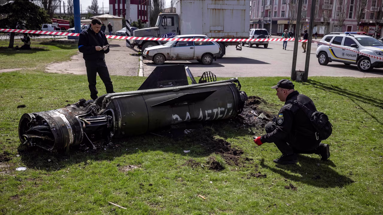 Ukrainian police inspect the remains of a large rocket next to the main building of a train station in Kramatorsk, Ukraine on April 8.