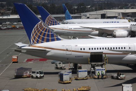 Workers load cargo onto a United Airlines plane at San Francisco International Airport on July 8.