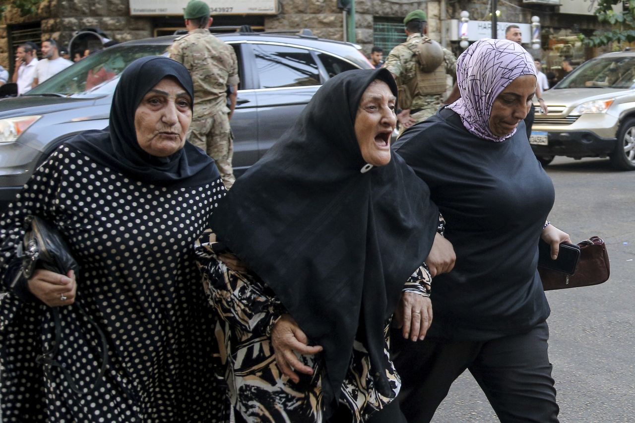 Women arrive to the American University hospital to check on their friends and family members on Tuesday.