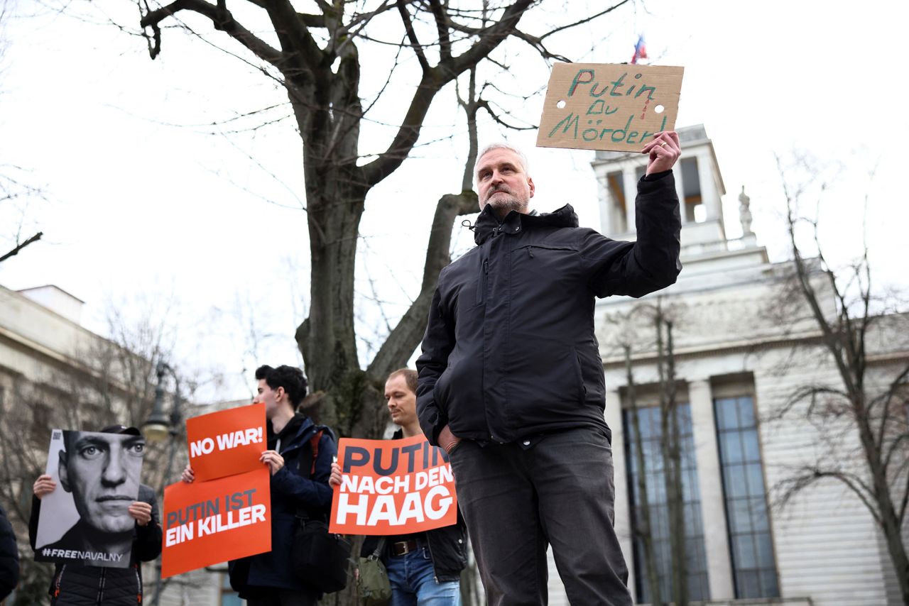 People hold placards as they gather in front of the Russian embassy in Berlin, Germany, on February 16.